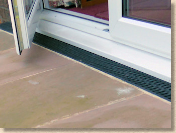 linear channel at doorway threshold