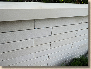 shot-textured off-white stone walling
