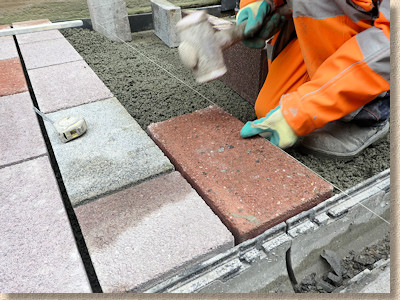 paver is hammered down to level