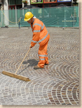 Construction Worker Grouting Dry Sand With Brush Into Paver Bricks Joints  During Road Works Stock Photo, Picture and Royalty Free Image. Image  55641666.